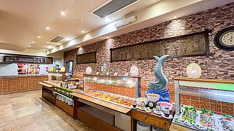Buffet restaurant with brick walls, hot food displays, and decorative lighting