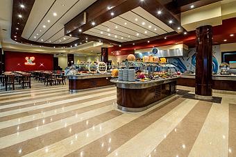 Modern buffet restaurant with food stations, polished floors, and decorative lighting