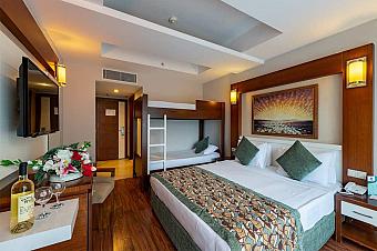 Family room with double bed and bunk bed, TV and small table.