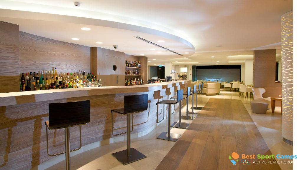 Hotel bar with counter seating and lounge area.