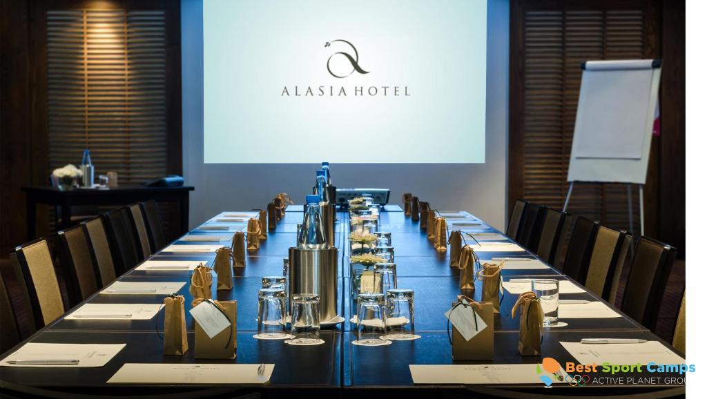 Conference room with long board table, projector screen and meeting setup.