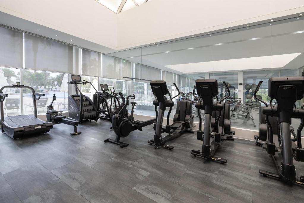Fitness room with treadmills, bikes, ellipticals and mirrored walls.