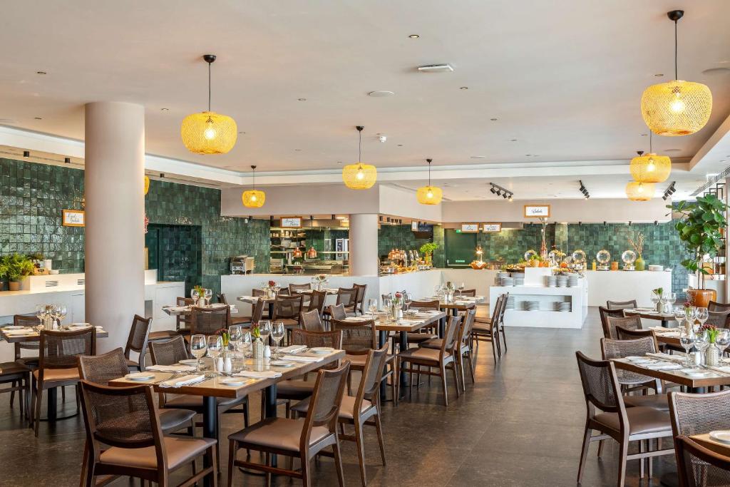 Restaurant dining room with buffet counters and set tables.