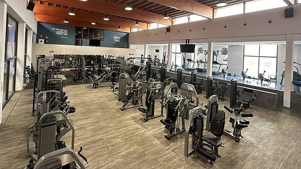Großer Fitnessraum mit Kraftgeräten und Cardio-Zone für Trainingslager-Workouts.