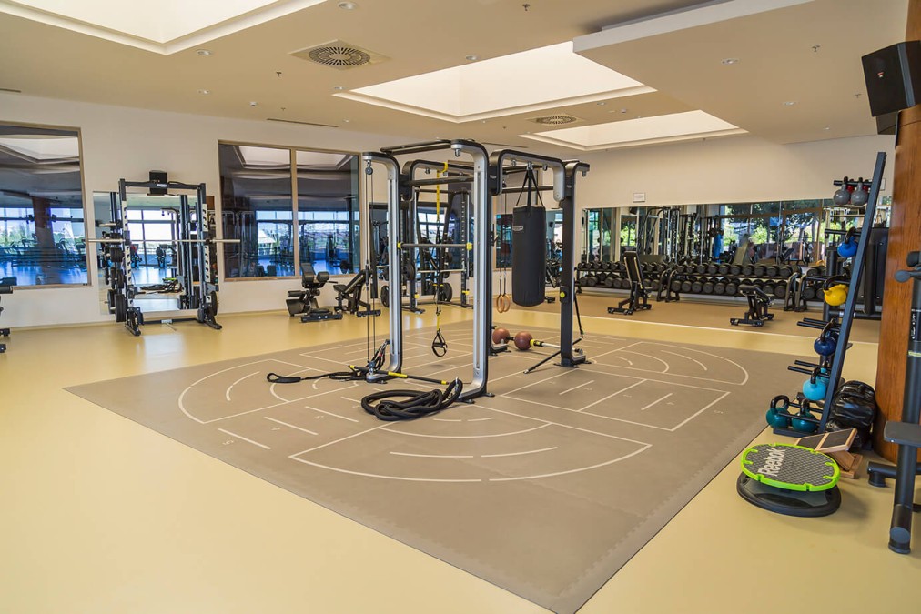Großzügiges Functional-Training-Studio mit Multistation-Rig, Schlingentrainern und Boxsack, ergänzt durch Freihanteln und Kettlebells. Die offene Fläche bietet viel Platz für Mobility, Dehnen und Zirkeltraining.