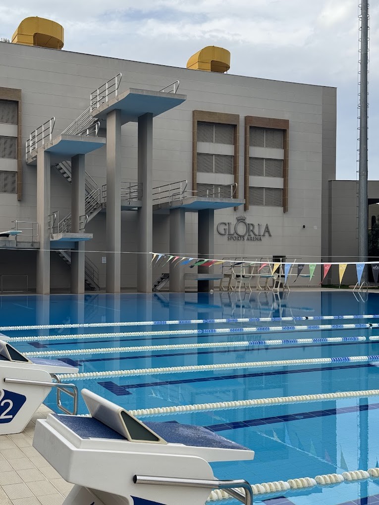 Sprungbecken mit mehrstöckigen Plattformen neben dem Sportarena-Gebäude.